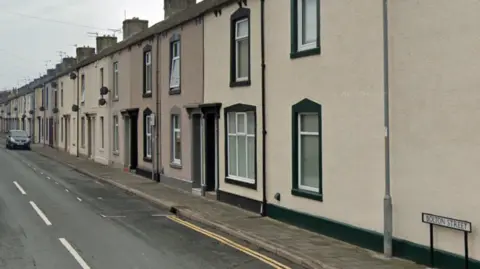 Google A street view of the terraced homes of Bolton Street. They are cream and beige coloured properties.