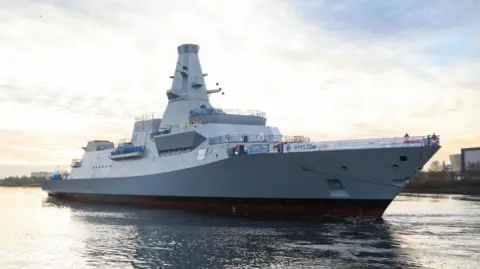 HMS Glasgow, aType 26 Frigate, makes its way to Scotstoun shipyard after being successfully floated on the Clyde.